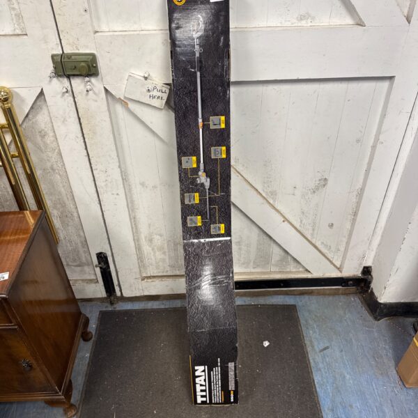 Sealed Titan 50cm electric pole hedge trimmer in original packaging.