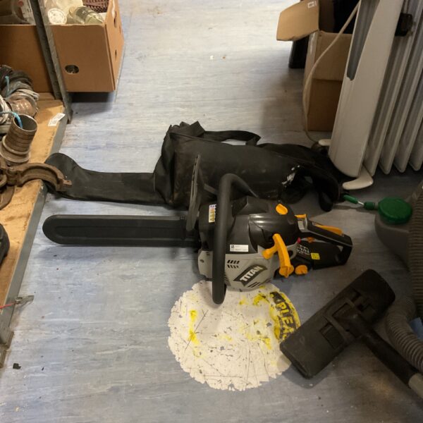 Titan TTL759CHN petrol chainsaw with protective bag for garden use.