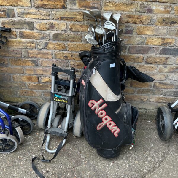 Titleist golf clubs set with trolley and bag, showing signs of use.