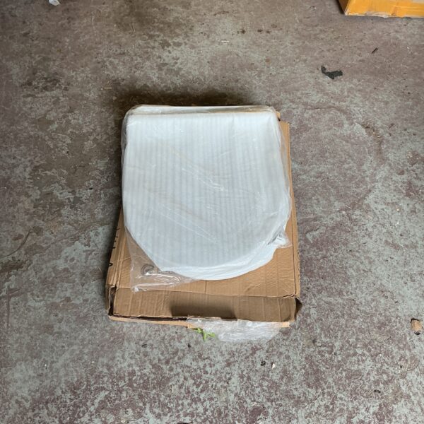 Lot of three new toilet seats in packaging.