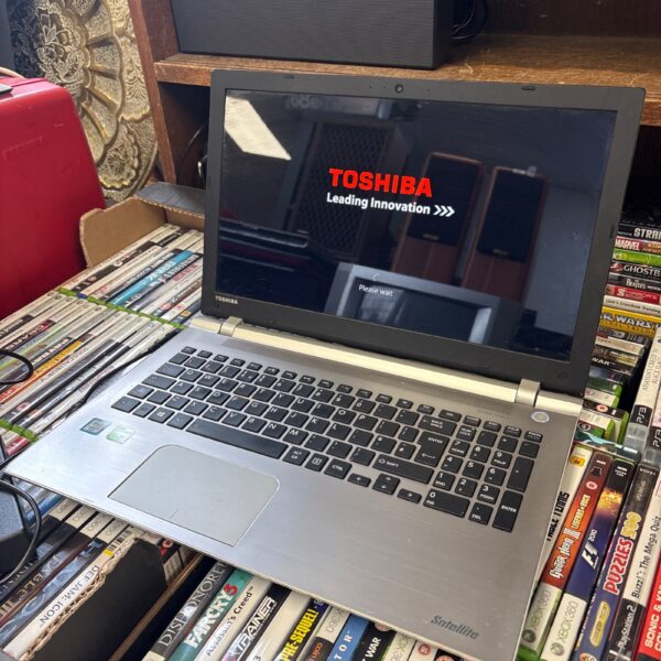 Toshiba Satellite P50-C laptop displayed with books.