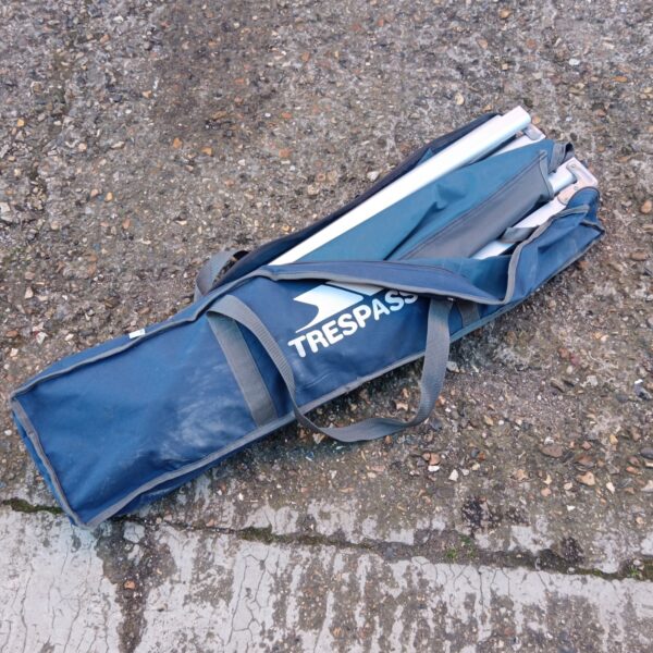 Folded Trespass camping bed ready for storage or transport.