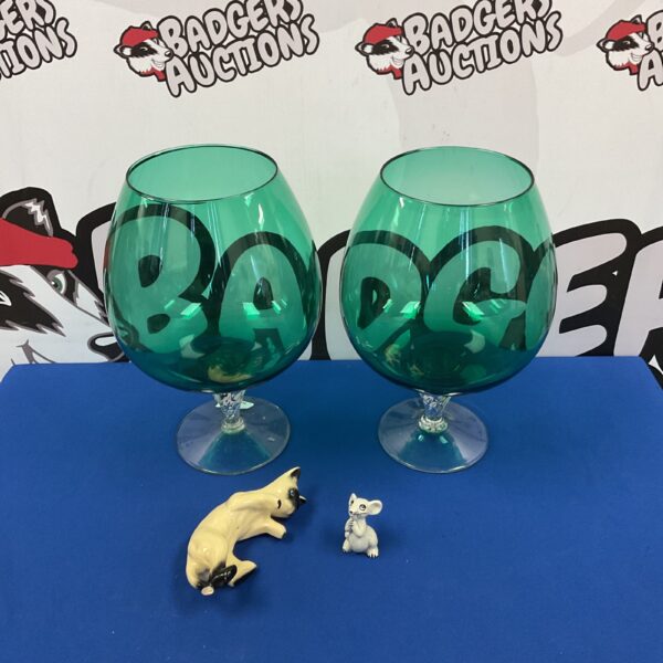 Pair of turquoise brandy glasses with cat and mouse figurines.