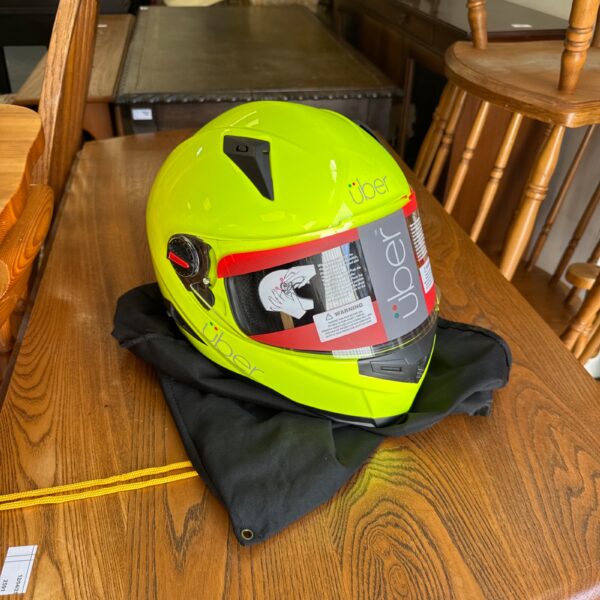 Bright yellow Uber motorcycle helmet, size XXL, with storage bag.