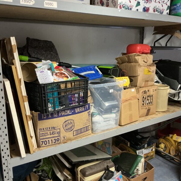 Mixed lot of unclaimed items including a vacuum cleaner.