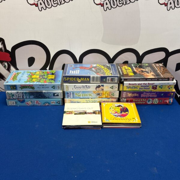 Assorted VHS and DVD tapes and cases in a lot.