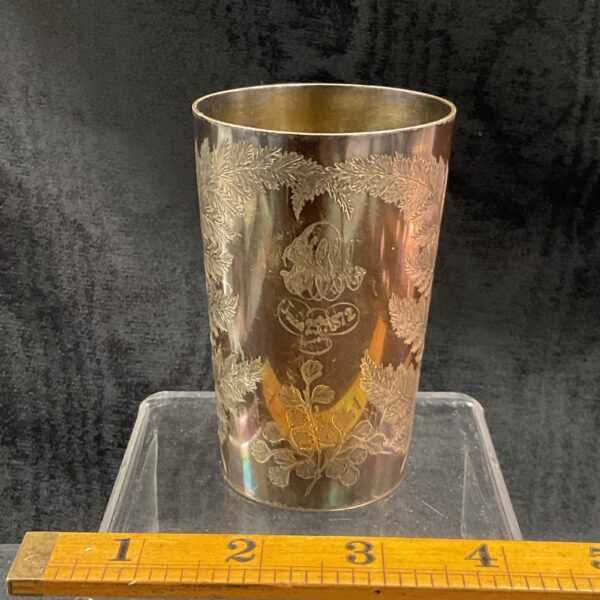 Antique Victorian silver tumbler with detailed floral engraving.