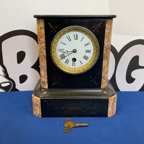 Victorian slate mantle clock with marble and Roman numerals.