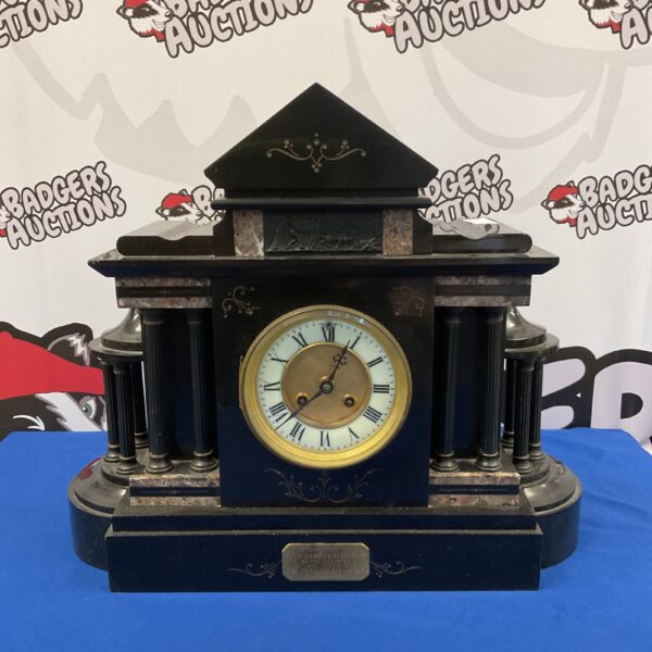 Front view of a Victorian slate mantle clock with marble details.
