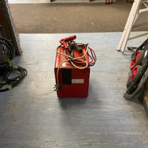 Red vintage AC arc welder, classic metalworking equipment.