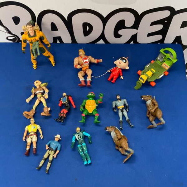 Vintage lot of action figures including He-Man, TMNT, and Batman.