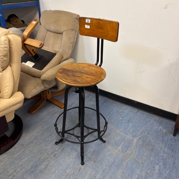 Vintage adjustable stool with wrought iron base and wooden seat.