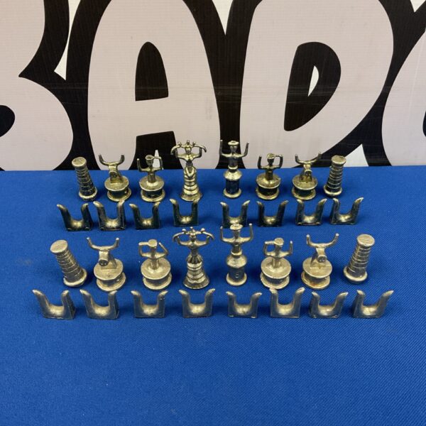 Vintage African chess pieces displayed on a blue surface.