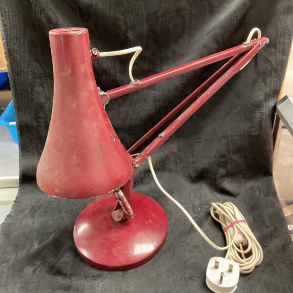 Red vintage Anglepoise Model 90 desk lamp with adjustable arm.