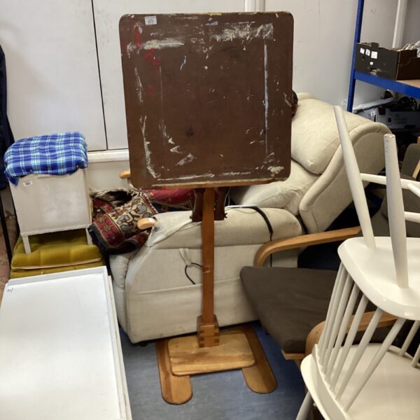 Vintage wooden artist easel in a studio setting.