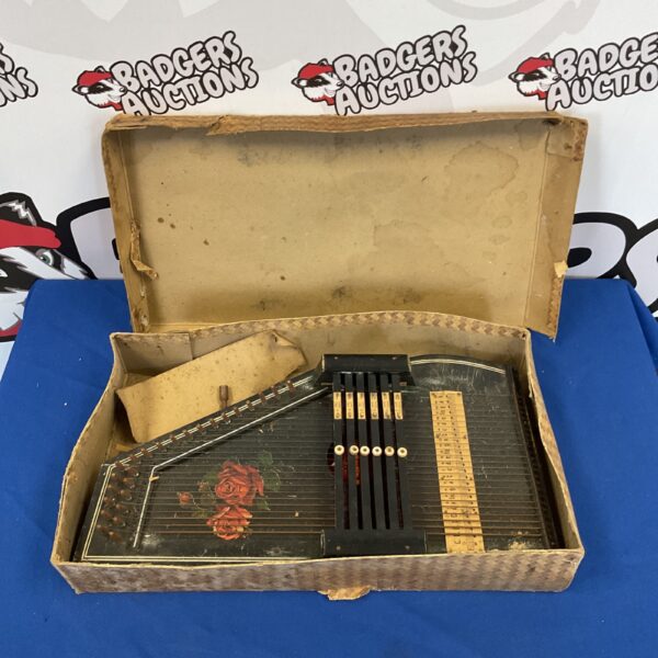 Front view of a vintage autoharp zither instrument.