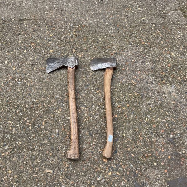 Pair of vintage axes with wooden handles and steel heads.