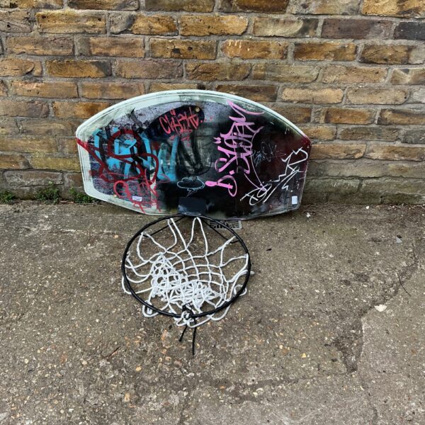 Vintage wall-mounted basketball hoop with acrylic backboard.