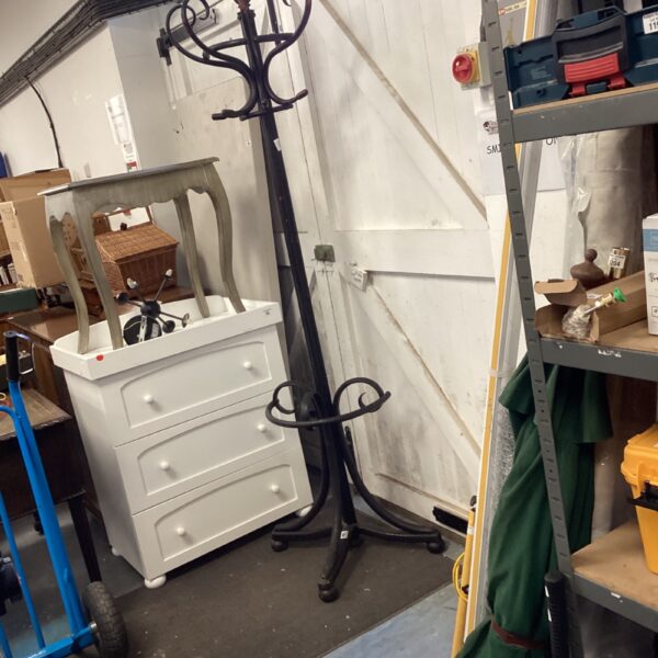 Vintage bentwood coat rack in a hallway setting.