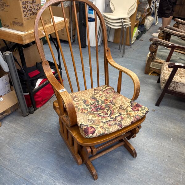 Vintage bentwood rocking chair with patterned seat cushion.
