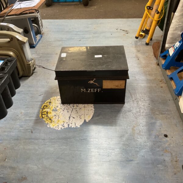 Vintage black metal deed box for secure document storage.