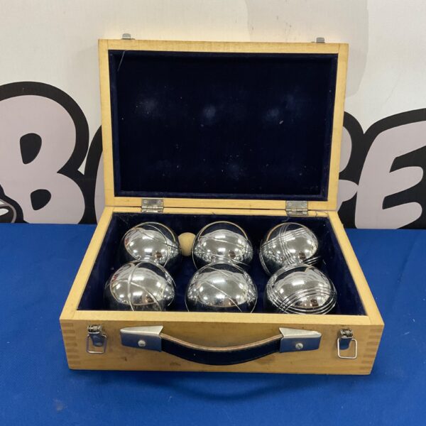 Vintage boules set in wooden case for outdoor games.