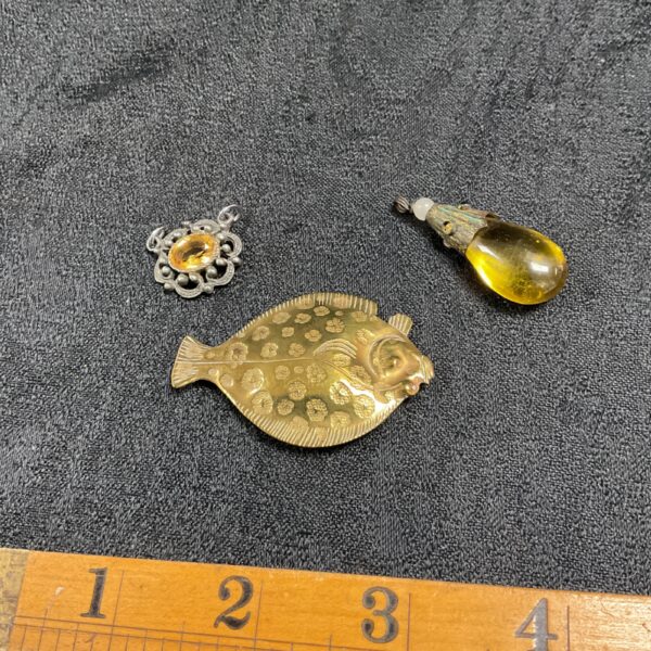 Vintage brass fish brooch and citrine amber pendants.