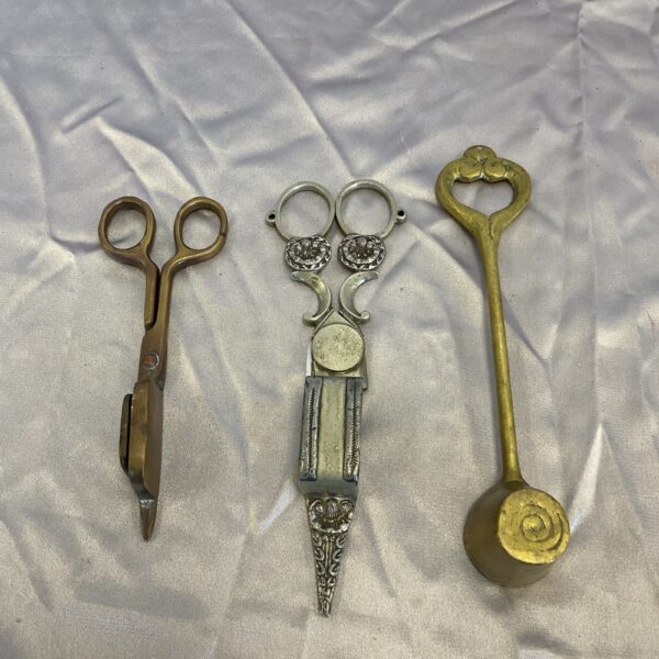 Antique brass candle snuffer with scissor action.