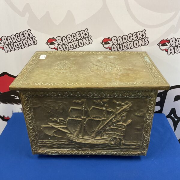 Vintage brass coal box with detailed ship design.