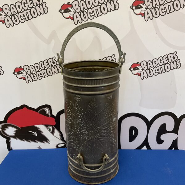 Vintage brass coal scuttle with floral design for hall decor.