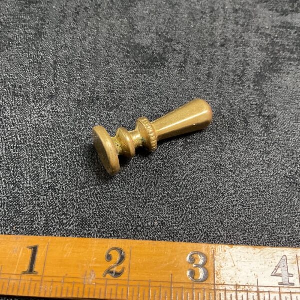 Vintage brass wax seal stamp with detailed engraving.