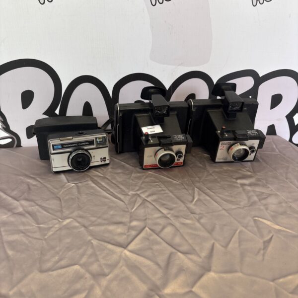 Vintage cameras lot including Polaroid and Kodak models.