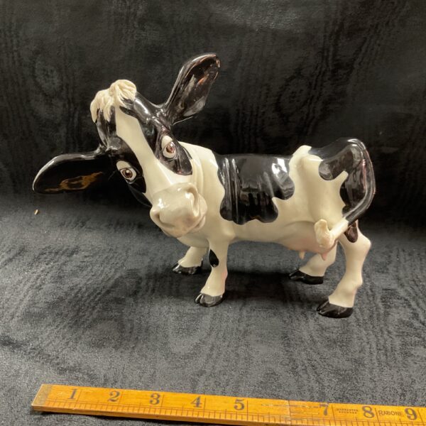 Vintage ceramic cow figurine for farmhouse decor.