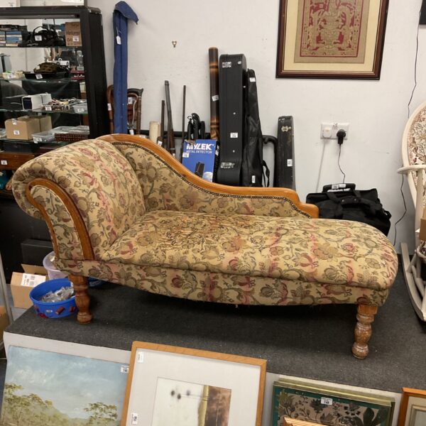 Vintage floral chaise lounge with a pine frame.