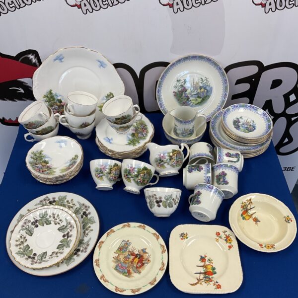 Vintage china tea set with floral patterns and gilded accents.
