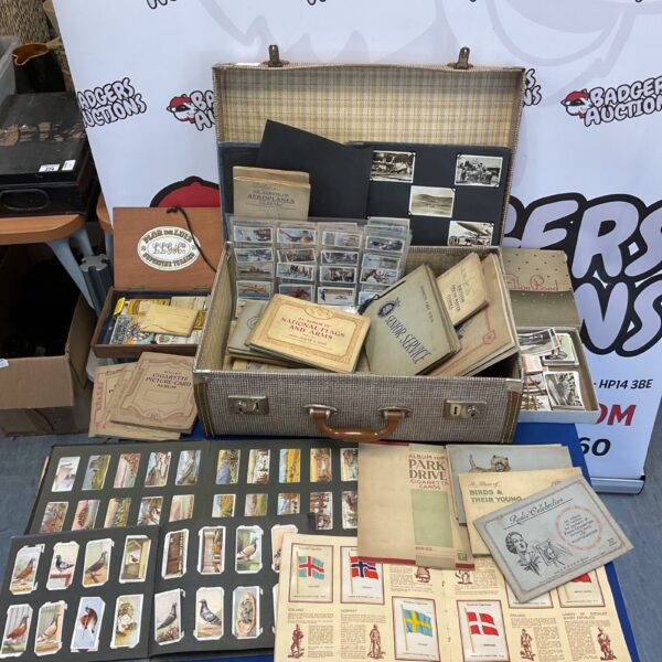 Vintage cigarette card collection displayed with open albums.
