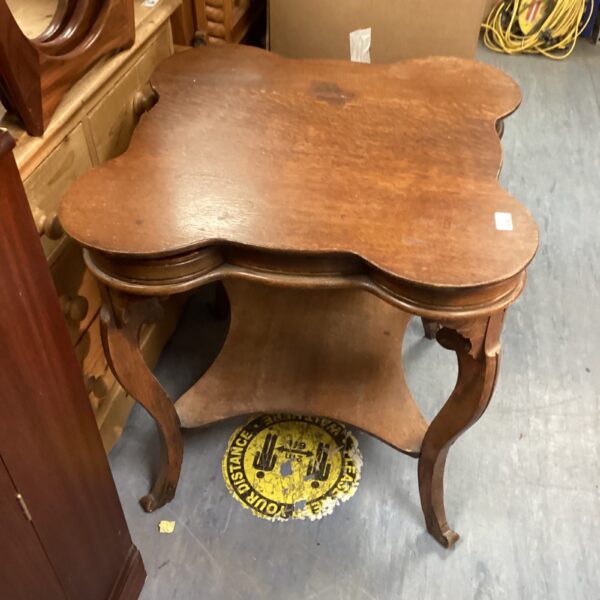 Vintage clover leaf card table with curved legs.