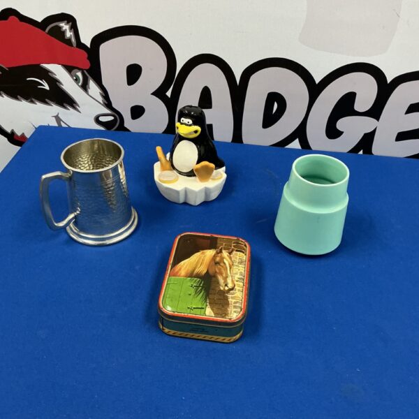 Vintage collectible lot featuring penguin, pewter mug, and Poole Pottery.