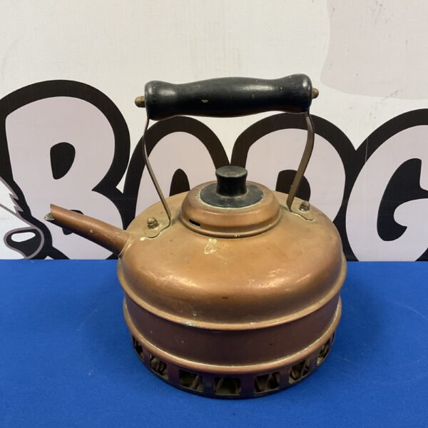 Vintage copper kettle with patina, a classic kitchen collectible.