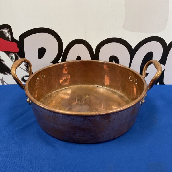 Front view of a vintage copper pan with handles.