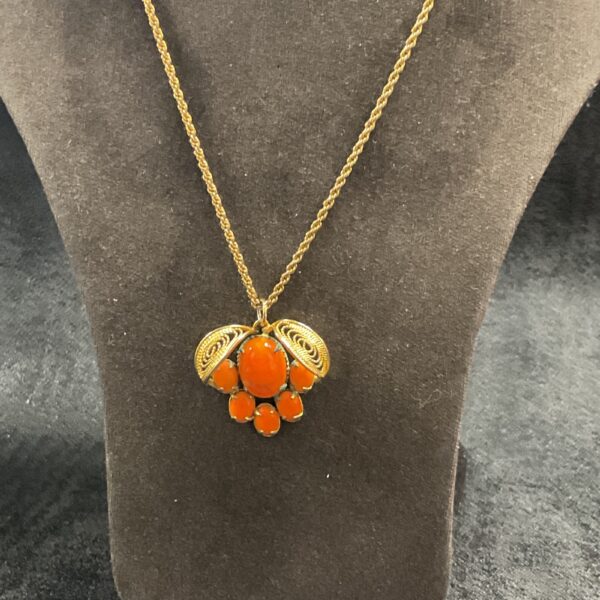 Vintage Cornelia necklace with five orange stones and gold tone chain.