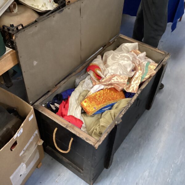 Vintage trunk overflowing with colourful oriental costume pieces.
