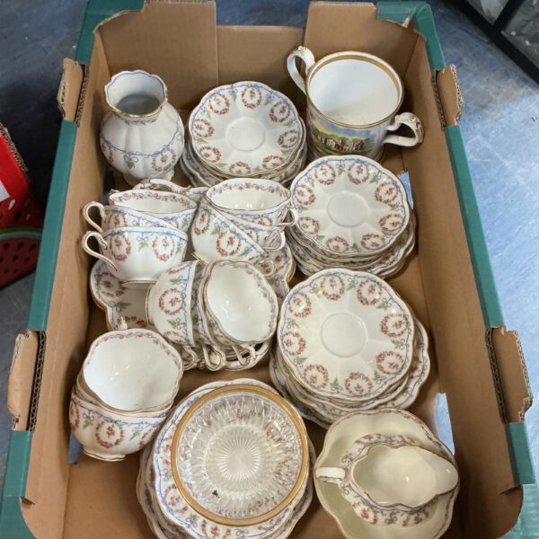 Vintage Crescent Pottery china teacup and saucer set with floral design.