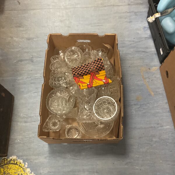 Vintage cut glass and crystal collection in a cardboard box.