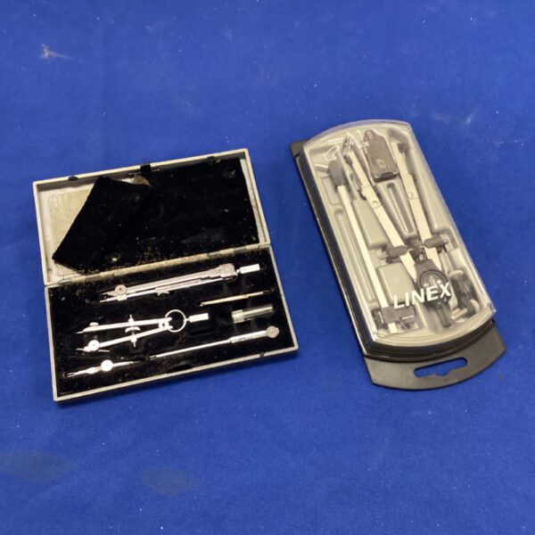 Vintage drafting instrument set in a grey case.