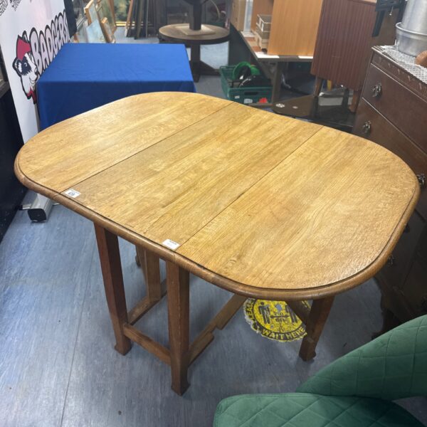 Vintage oak drop leaf table with leaves down.