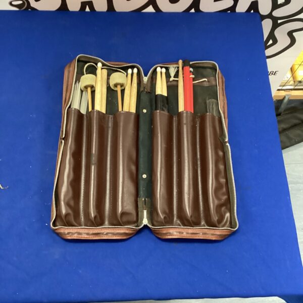 Vintage leather drum stick case with sticks inside.