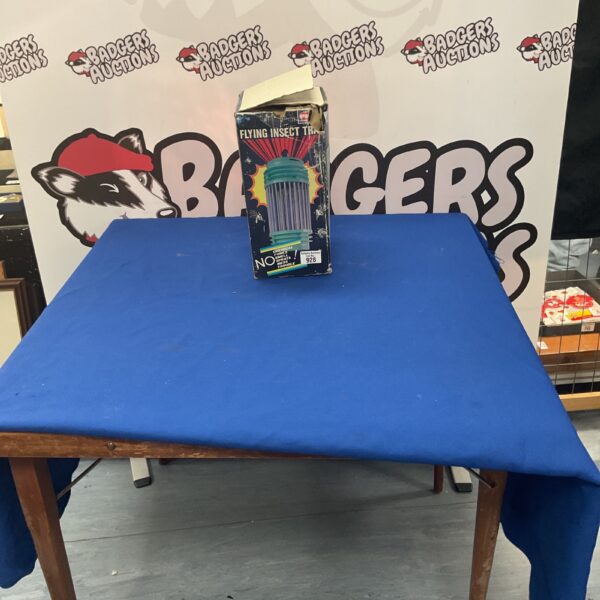 Vintage electric flying insect killer on a wooden table.