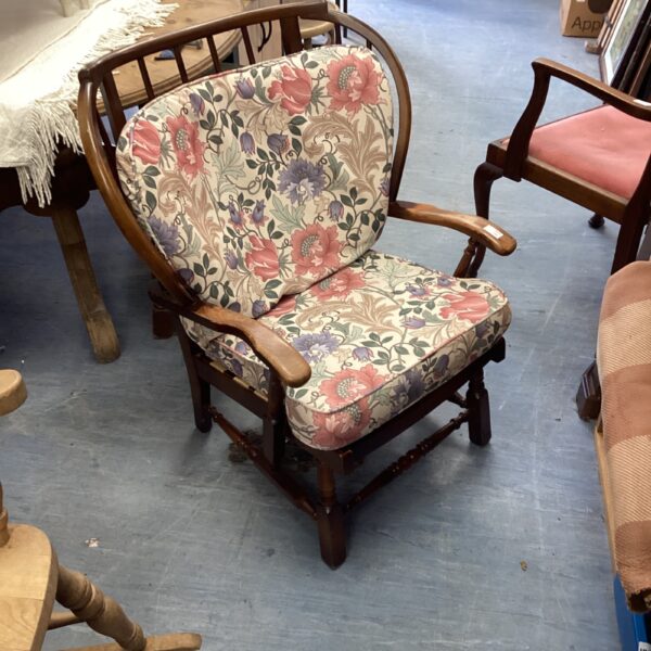 Vintage Ercol armchair with colourful floral upholstery.
