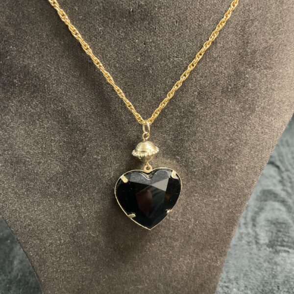 Vintage faceted heart necklace on gold tone chain.